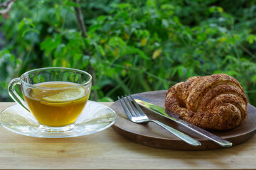 Hot Tea with croissant bread on  Wooden Bar