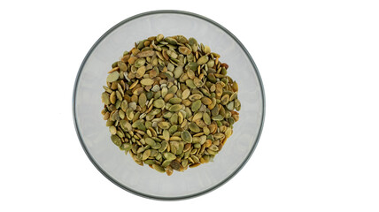 peeled pumpkin seeds in a plate on a white background