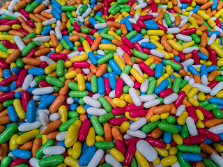 A bunch of bright colored marmalade is on the counter in a candy store