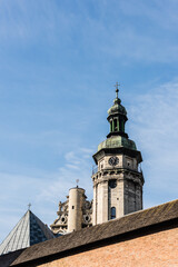 Fototapeta na wymiar korniakt tower and monastery wall against blue sky in lviv, ukraine