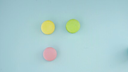 Three Macaroons or macaron on pastel blue surface