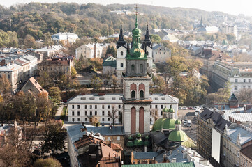 Fototapeta na wymiar aerial view of carmelite church, korniakt tower and houses in historical center lviv, ukraine