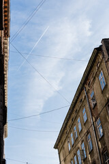 low angle view of old houses and electrical wires against blue sky in lviv, ukraine
