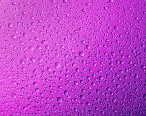 The texture of the water. Drops on a purple surface
