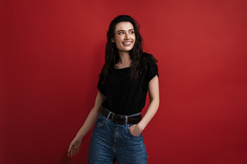 Photo of joyful young woman in casual wear posing and smiling