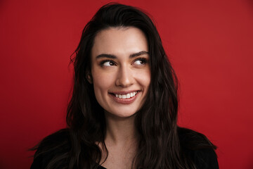Photo of brunette cheerful woman smiling and looking aside