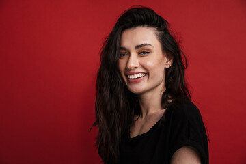 Photo of brunette cheerful woman in casual t-shirt laughing at camera