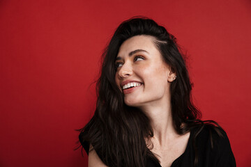 Photo of brunette cheerful woman smiling and looking aside