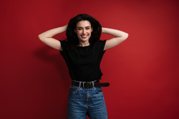 Photo of young cheerful woman in casual t-shirt laughing and grabbing her head