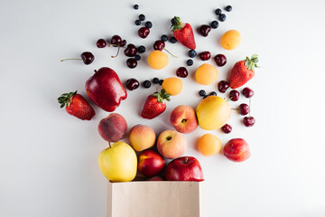Healthy vegetarian vegan clean food in paper bag fruits on white background