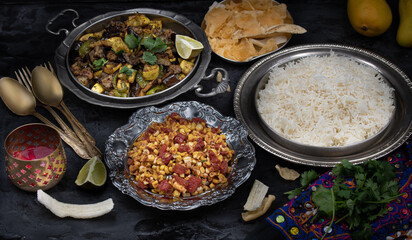 Vegan Indian dishes served in exotic bowls on dark table