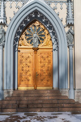 wooden church door with beautiful wood carvings in a suburban park near St. Petersburg, Russia