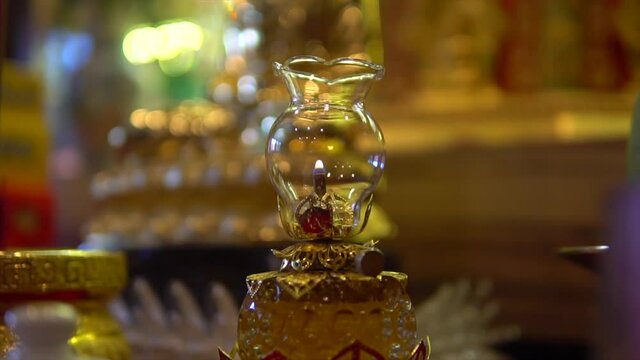 Dhatu or sarira are small that look like pearls or crystals formed after the body is cremated after the death of Buddhist monks. Small golden and shiny buddha statue.
