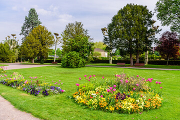 Green lawn with flowers in l'orangerie park - city Park in Strasbourg, France