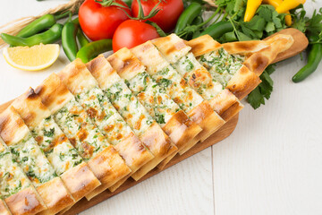 Turkish pizza with mixed cheese and herbs