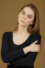 Fototapeta premium Beautiful young red-haired and fair-skinned girl posing in the studio on a light background. Blue eyes.