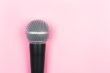 ASMR, karaoke, singing, voice recording concept.  A microphone on pink background. Minimal...
