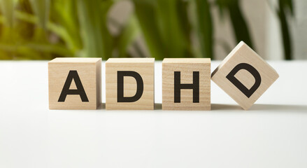 ADHD text on a wooden building blocks on grey background. Attention deficit hyperactivity disorder awareness, mental disorder of children. Medical term - obrazy, fototapety, plakaty