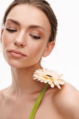 Fototapeta premium Image of beautiful caucasian young happy shirtless woman holding flower