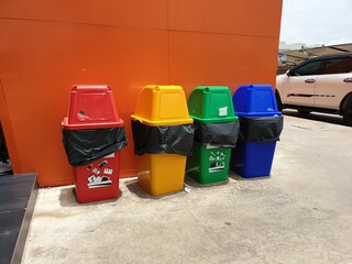 Many different colors of waste bin for paper, plastic, glass and danger waste for easy to recycle.