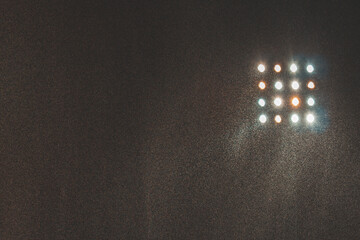 Spotlight of football or soccer stadium with rain water at night time.