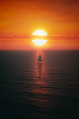 sailboat on the sea at dreamy red sunset