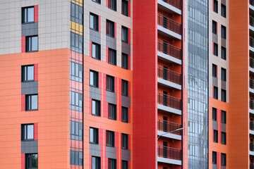 built colorful house with panoramic balconies near the construction site in the new residential district. concrete building technology 