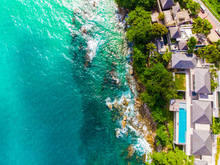 Modern resort hotel on mountain island sea beach turquoise water