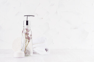 White elegant toiletry for body and skin care in light exquisite home interior with dry flowers with copy space.