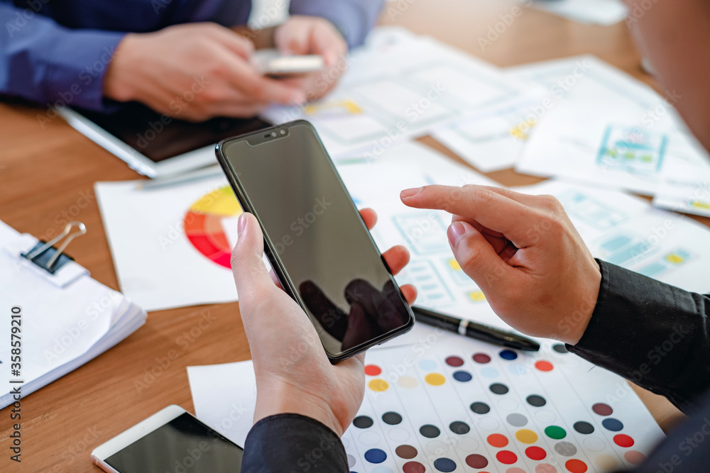 Aufkleber group of designer creativity drawing a website outline and website ux app development on mobile phon