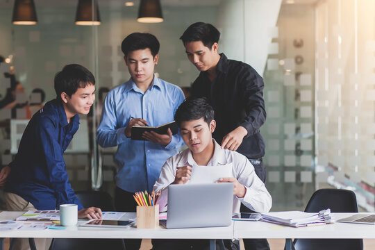 Meeting of young asian business people who are committed to work. Creative business team sitting working together at office.