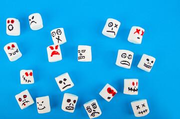 Fototapeta na wymiar Marshmallows close-up and copy space on blue background. Marshmallows for Halloween emoticons. 