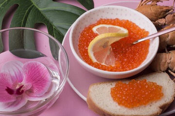 Red caviar and boiled crayfish. Light restaurant snack.