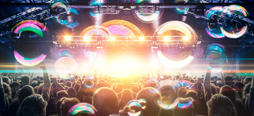 Concert photography during a gig,this is the point of view of the crowd in front of a stage during...