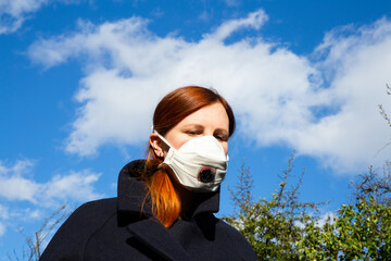 Beautiful woman wearing respiratory mask for the new rapidly spreading Coronavirus, COVID-19