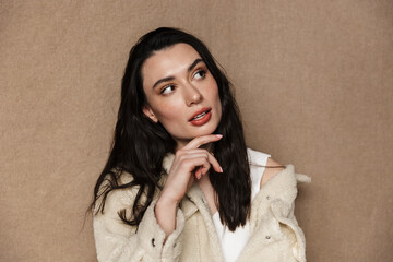 Photo of thinking beautiful woman in jacket posing and looking aside