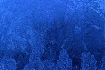 Fototapeta na wymiar beautiful ice flower shapes and patterns on frost frozen window