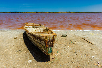 It's African boats on the coast of the pink water lake in Senegal, Africa