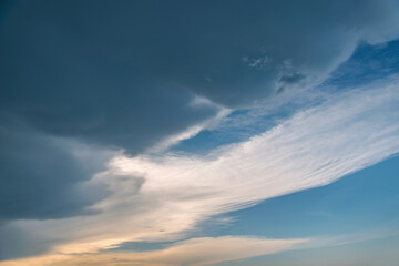Fototapeta premium Dark storm clouds before rain at sunset.