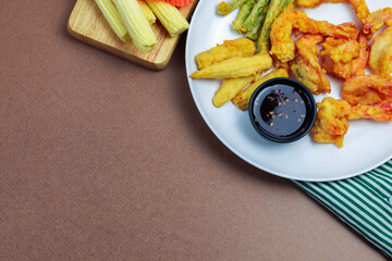 Batter fried shrimp on a brown background. Copy space