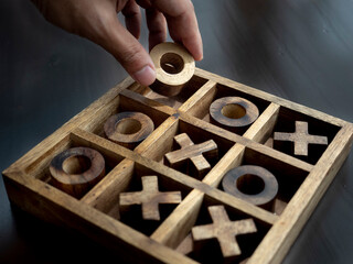 Wooden tic tac toe OX game The concept of strategy, risk, competition. 