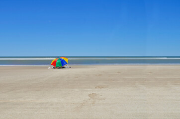 Fototapeta na wymiar Colorful umbrella on the beach