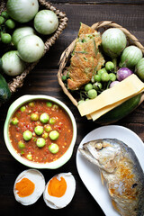 Shrimp Paste Chilli Sauce with Fried Mackerel and vegetable, (nam prik ka pi) on wood table, top view - obrazy, fototapety, plakaty