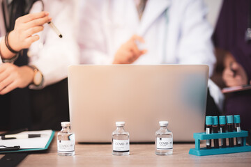 Doctor medical team is discussing the vaccine test results for treatment of patients infected...