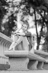 Black and white photo of a ballerina girl in jeans and pointe shoes, dancing and posing in the city on the street © Tatiana