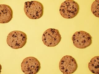 Chocolate Chip Cookies in a pattern on a yellow background, Top View