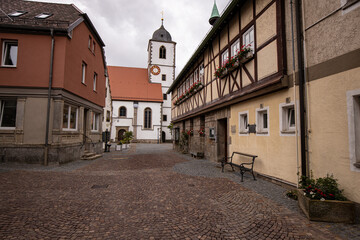 Fototapeta na wymiar Cityview of Street of Waldenburg with Old Church Tower and Buildings, Germany Europa