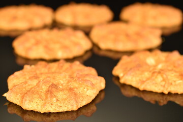 Fragrant tasty, sweet cereal cookies, close-up, on a black background.