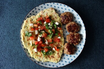 Greek grill meatball on pita with tomato and cucumbers