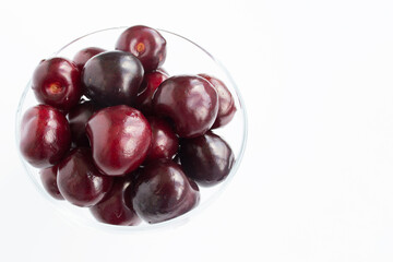 Sour cherries, close-up view. White background. Copy space.